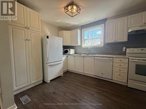 Ajax (South East) apartment for rent - A kitchen with white appliances and cabinets.
