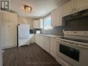 Ajax (South East) apartment for rent - A kitchen with white appliances and wooden floors.