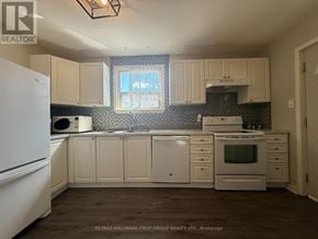 Ajax (South East) apartment for rent - A kitchen with white appliances and cabinets.