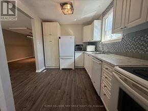 Ajax (South East) apartment for rent - A kitchen with white appliances and wooden floors.