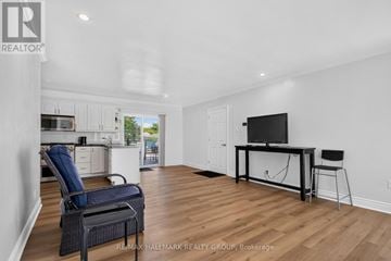 Ottawa apartment for rent - A spacious living room with a television and a chair.