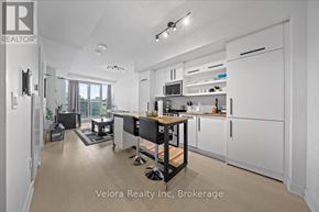Ottawa condo for rent - A modern kitchen with white cabinets and a black island.