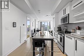 Ottawa condo for rent - A modern kitchen with a black countertop and stainless steel appliances.