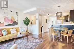 Ottawa townhouse for rent - A living room with a yellow couch and a dining table with chairs.