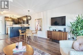 Ottawa townhouse for rent - A living room with a wooden floor and a television on the wall.