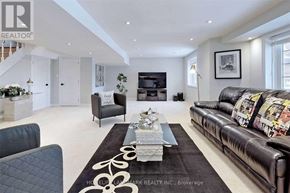 Richmond Hill (Jefferson) apartment for rent - A living room with a black leather couch and a coffee table in the middle.