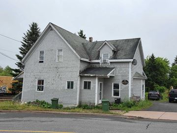 Stellarton apartment for rent - A grey house with a sign on the front.