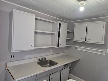 Stellarton apartment for rent - A kitchen with white cabinets and a sink.