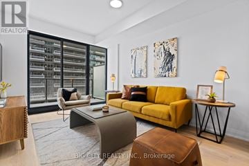 Toronto (Thorncliffe Park) condo for rent - A living room with a yellow sofa and a coffee table.