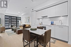 Toronto (Thorncliffe Park) condo for rent - A modern kitchen with a dining table and chairs.