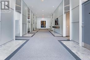 Toronto (Bay Street Corridor) condo for rent - A long, narrow hallway with a marble floor and white walls.