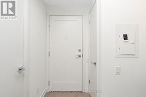 Toronto (Bay Street Corridor) condo for rent - A white door is in the middle of a hallway.