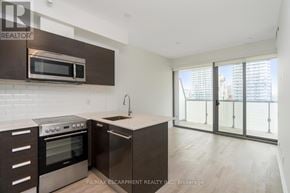 Toronto (Bay Street Corridor) condo for rent - A modern kitchen with a stainless steel oven and microwave.