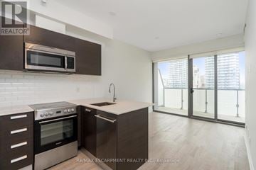 Toronto (Bay Street Corridor) condo for rent - A modern kitchen with a stainless steel oven and microwave.