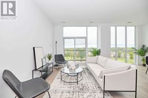 Niagara Falls (Oldfield) condo for rent - A living room with a white couch, a black chair, a coffee table, and a large window overlooking the outdoors.