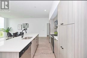 Niagara Falls (Oldfield) condo for rent - A modern kitchen with white countertops and wooden cabinets.