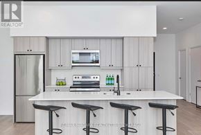 Niagara Falls (Oldfield) condo for rent - A modern kitchen with white cabinets and a central island with a bar stool.