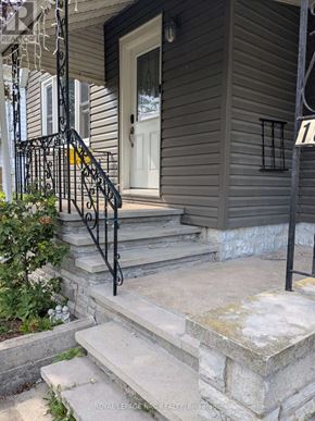 Port Colborne (Main Street) apartment for rent - A house numbered 11 with a white door and a black metal railing.