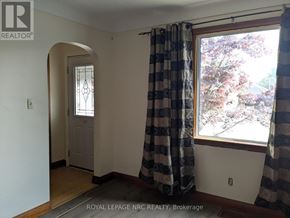 Port Colborne (Main Street) apartment for rent - A room with a checkered curtain and a door.