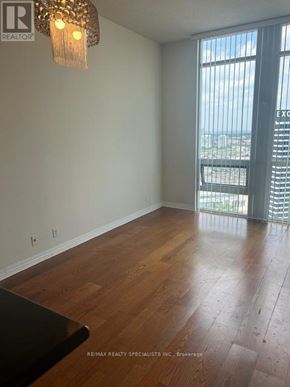 Mississauga (City Centre) condo for rent - A room with wooden floors and a window with blinds.