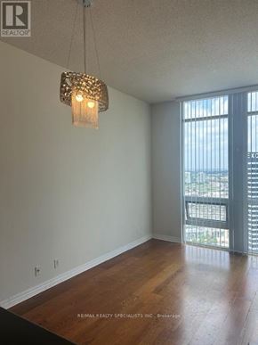 Mississauga (City Centre) condo for rent - A room with a wooden floor and a chandelier hanging from the ceiling.