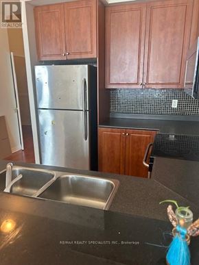 Mississauga (City Centre) condo for rent - A kitchen with a refrigerator, cabinets, and a sink.
