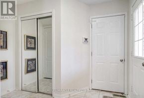 Brampton (Sandringham-Wellington) apartment for rent - A white door is in a room with a wall of framed pictures.