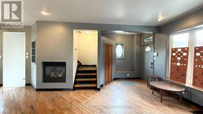 London South (South E) apartment for rent - A living room with a fireplace and a wooden floor.
