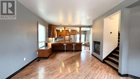 London South (South E) apartment for rent - A spacious living room with hardwood floors and a staircase leading to the upper level.
