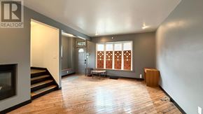 London South (South E) apartment for rent - A spacious living room with wooden floors and a large window with a wooden blind.
