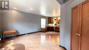 London South (South E) apartment for rent - A room with a wooden floor and a wooden door.