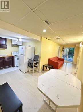 Mississauga (Hurontario) apartment for rent - A kitchen area with a refrigerator, dishwasher, and a table.