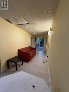 Mississauga (Hurontario) apartment for rent - A hallway with a red couch and a black table.