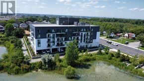 Hamilton condo for rent - A modern building with a large parking lot in front of it.