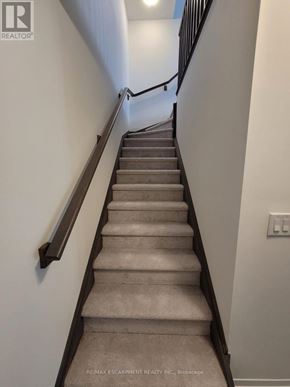 Brantford townhouse for rent - A staircase with a light switch on the wall.