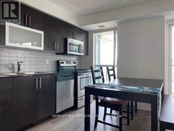 Toronto (Bendale) condo for rent - A kitchen with dark wood cabinets and a black countertop.