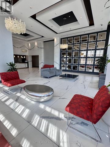 Vaughan (Vaughan Corporate Centre) condo for rent - A modern living room with red chairs and a marble floor.