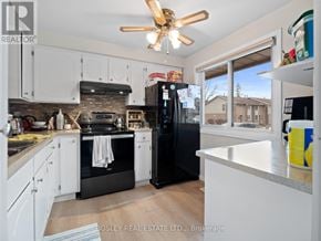 Niagara Falls (Stamford) townhouse for rent - A kitchen with a refrigerator, oven, and sink.