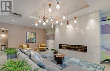 Milton (Cb Cobban) condo for rent - A living room with a couch, a coffee table, and a fireplace.