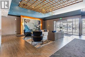 Hamilton (Waterdown) condo for rent - A real estate office with a large painting and a view of the street outside.