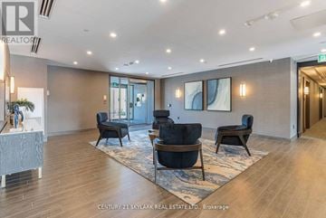Hamilton (Waterdown) condo for rent - A living room with a couch, chairs, and a painting on the wall.