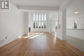 Loyalist (Bath) apartment for rent - A spacious room with wooden floors and white walls, with a large window allowing natural light to enter.