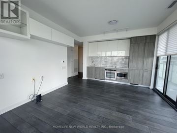 Toronto (Church-Yonge Corridor) condo for rent - A spacious living room with a kitchen in the background.