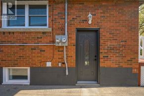 Hamilton (Hampton Heights) apartment for rent - A brick house with a black door and a window.