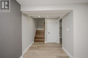 Hamilton (Hampton Heights) apartment for rent - A hallway with a white door and wooden stairs.