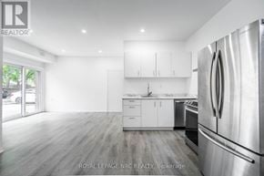 Port Colborne (Main Street) apartment for rent - A modern kitchen with white cabinets and stainless steel appliances.