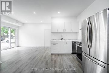 Port Colborne (Main Street) apartment for rent - A modern kitchen with white cabinets and stainless steel appliances.