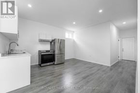 Port Colborne (Main Street) apartment for rent - A white kitchen with a refrigerator, oven, and sink.