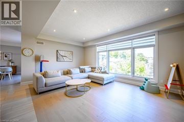 Kitchener apartment for rent - A living room with a white couch and a large window.