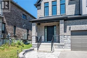 Kitchener apartment for rent - A house with a stone facade and a black door.